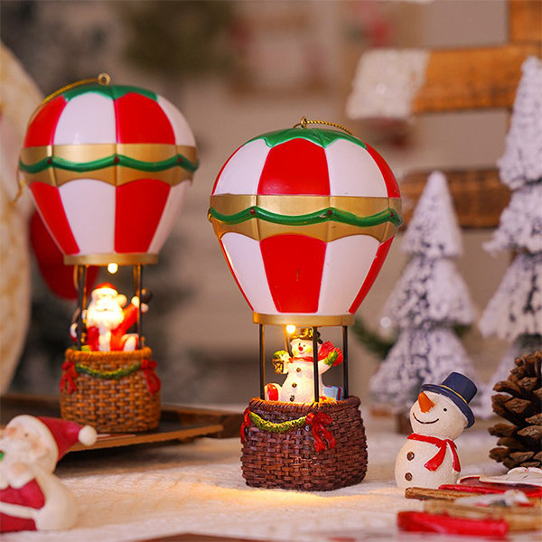 Fun Santa Claus sitting in a hot air balloon with decorative pendant lights